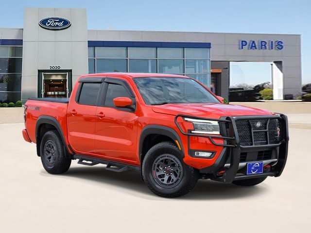 2025 Nissan Frontier PRO-4X in Afterburn Orange — front three-quarter view